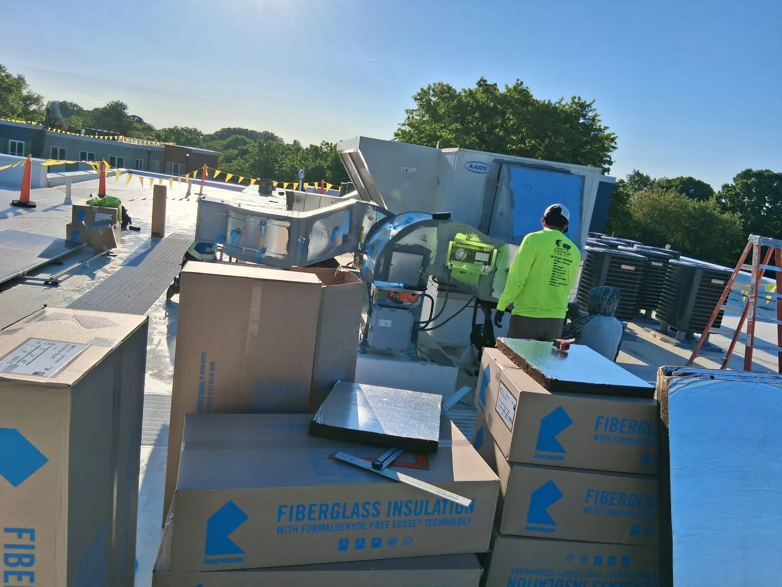Fiberglass insulation stock and cutting station staged on a jobsite