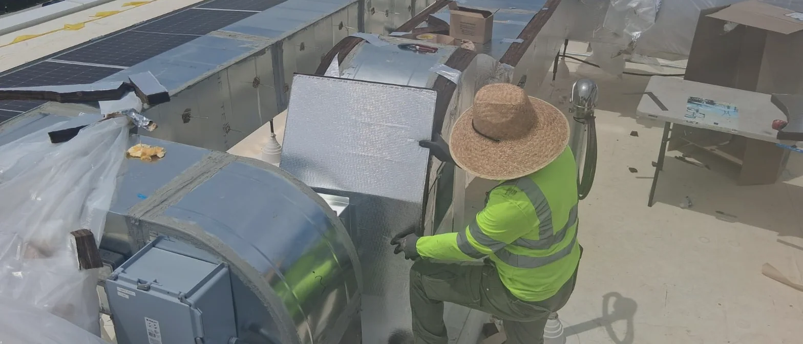 Sabaoth FQ insulator in a straw hat fitting foil-faced insulation on rooftop ductwork