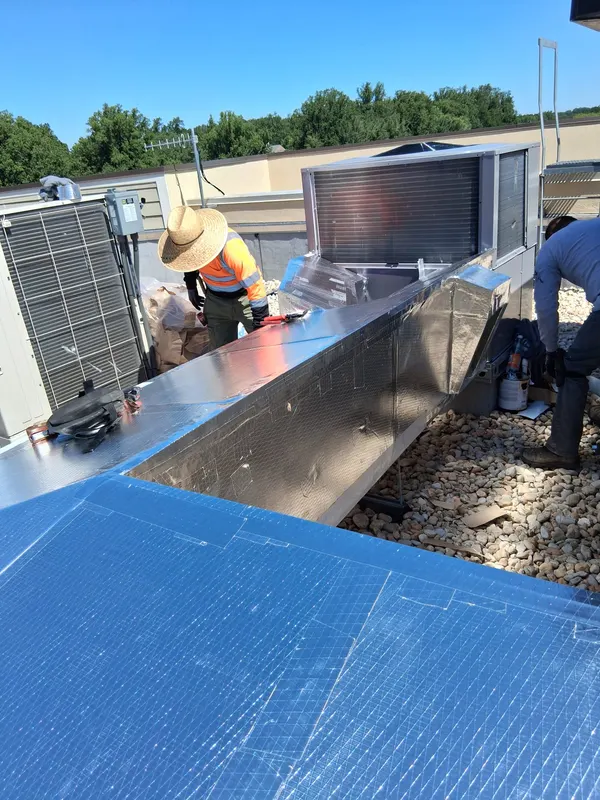 Metal jacketed duct run beside rooftop equipment