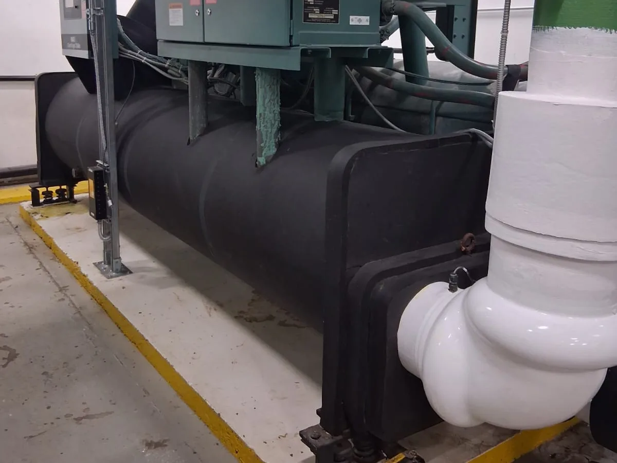Insulated vessel with a PVC jacketed elbow inside a mechanical plant room