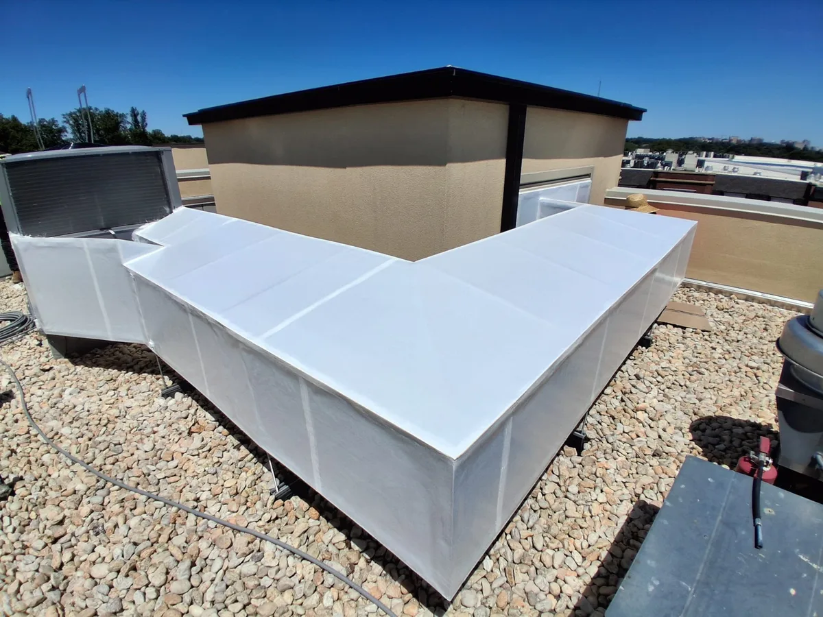 Foil faced duct insulation installed in a V pattern on a commercial roof